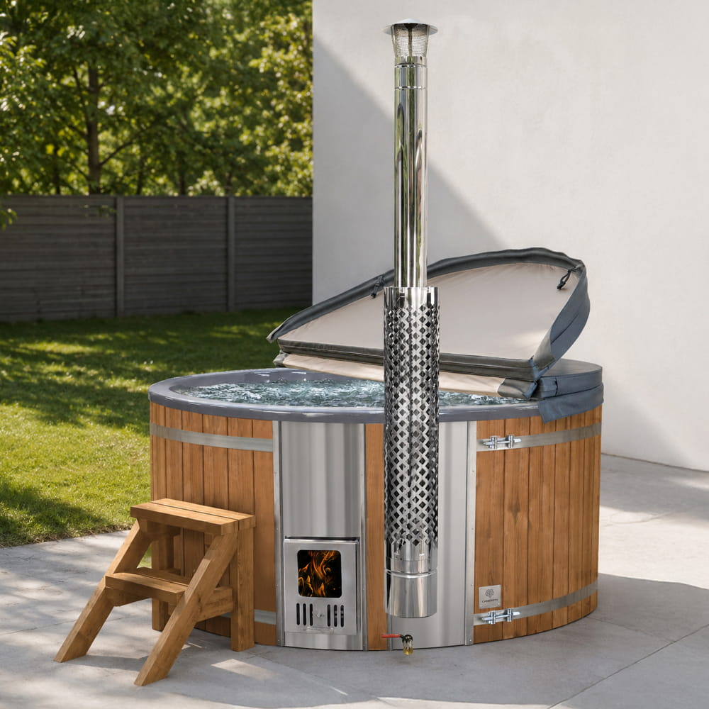 Off-grid wood-fired hot tub with a stove, chimney and wooden steps in an outdoor setting.