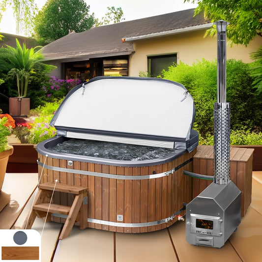 A metallic grey acrylic wood fired hot tub with ThermoWood cladding, featuring an external AISI 304 stainless steel heater and chimney, placed on a wooden deck with a garden in the background.