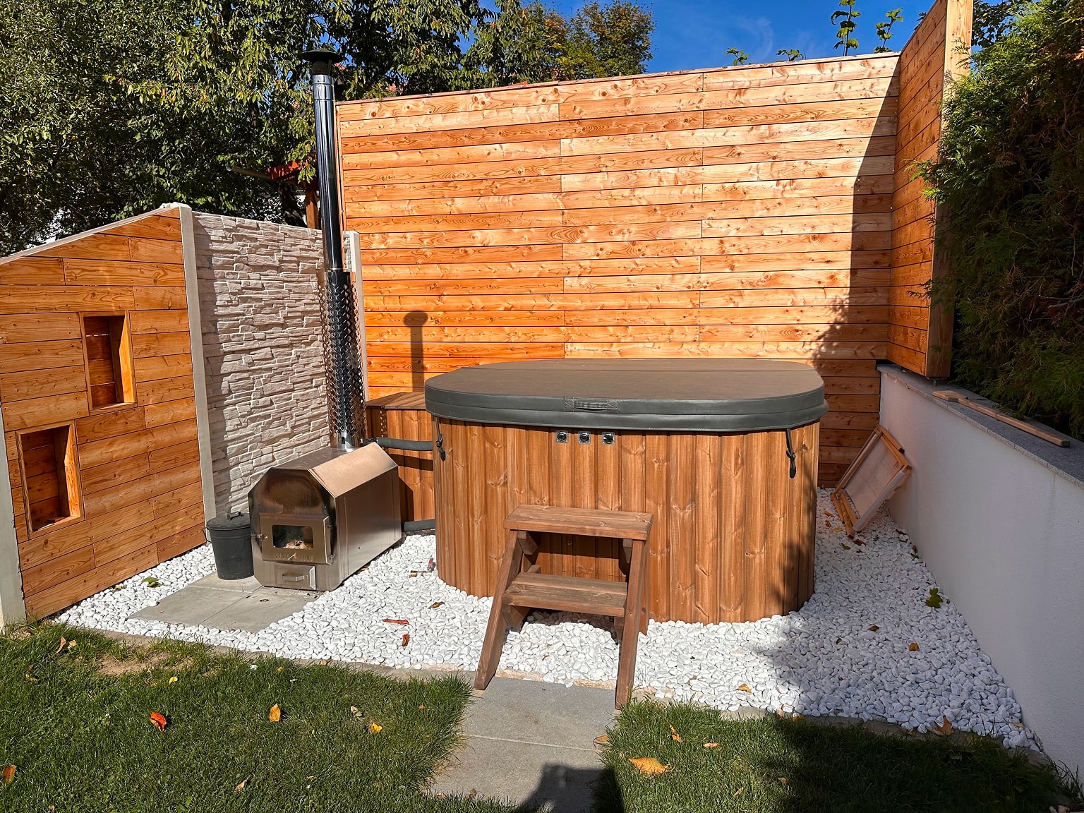 Square Gardenvity wood fired hot tub with external heater in modern private patio